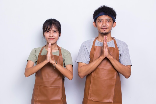 Asian couple barista wears apron waiter welcoming customer isolated on white background