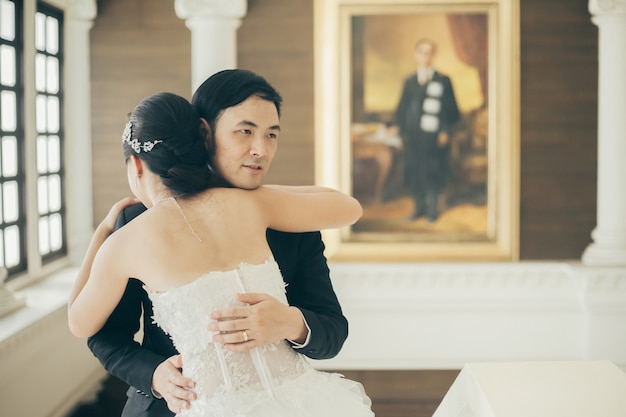 Asian couple dancing at their wedding