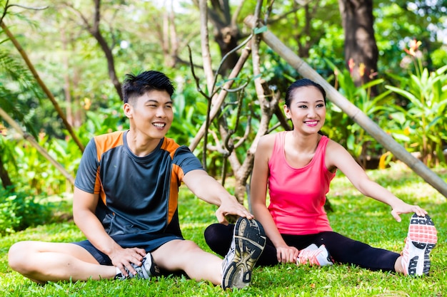 Asian couple having outdoor fitness sport training