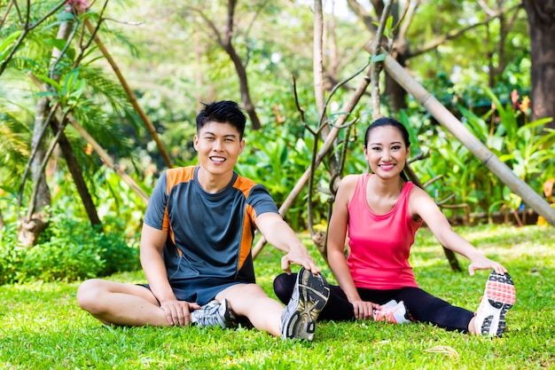 Asian couple having outdoor fitness sport training