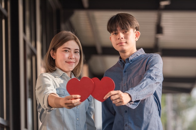 Asian couple holding red heart