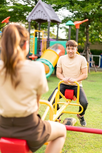 Asian couple love play seesaw