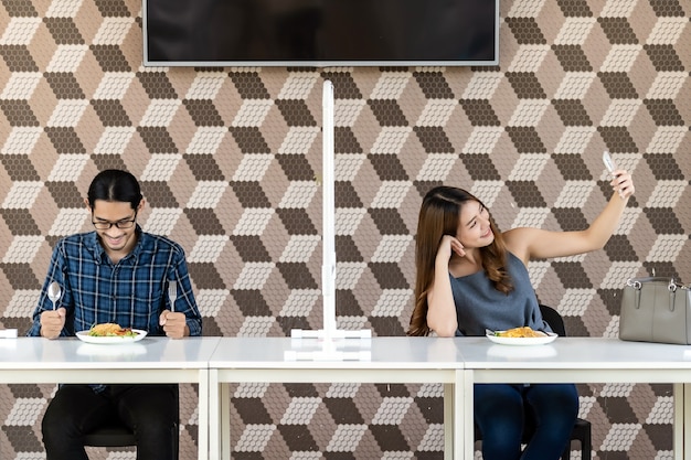 Asian couple in new normal restaurant