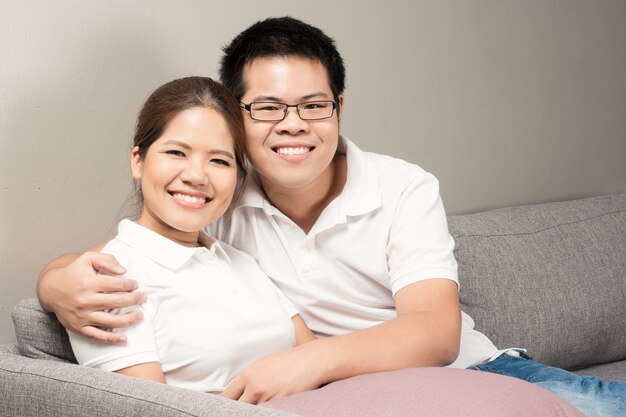 Asian couple relaxing on couch