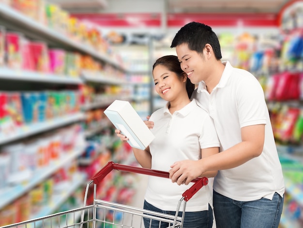 Asian couple shopping in supermarket