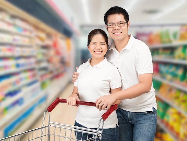 Asian couple shopping in supermarket