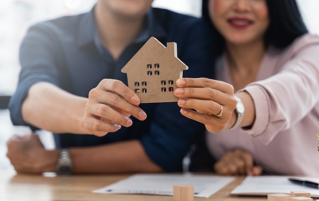 Asian couple showcasing their new home model after they have finished their home contract