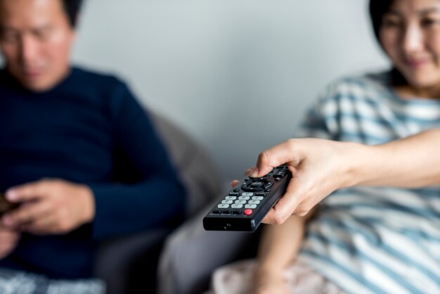 Asian couple watching movie at home together