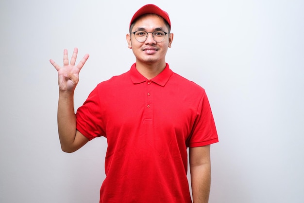 Asian courier man wearing delivery uniform and cap showing and pointing up with fingers number ten while smiling confident