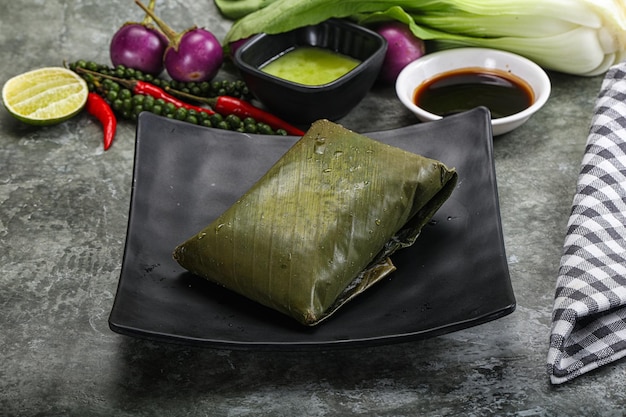 Asian cuisine rice with filling in banana leaf