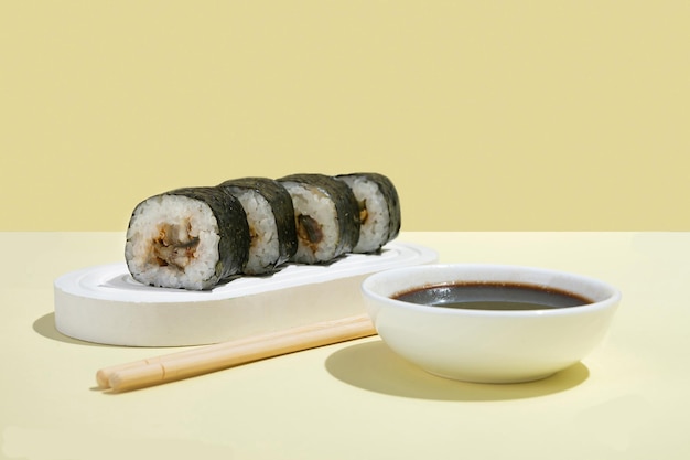 Asian culture Japanese hosomaki sushi rolls with eel on a yellow background Oriental culinary eastern cooking