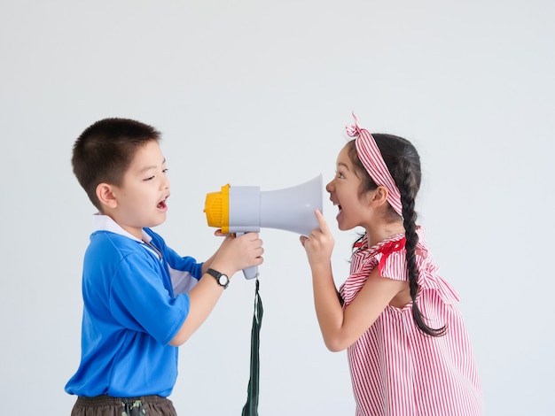 Asian cute boy and girl with megaphone singing