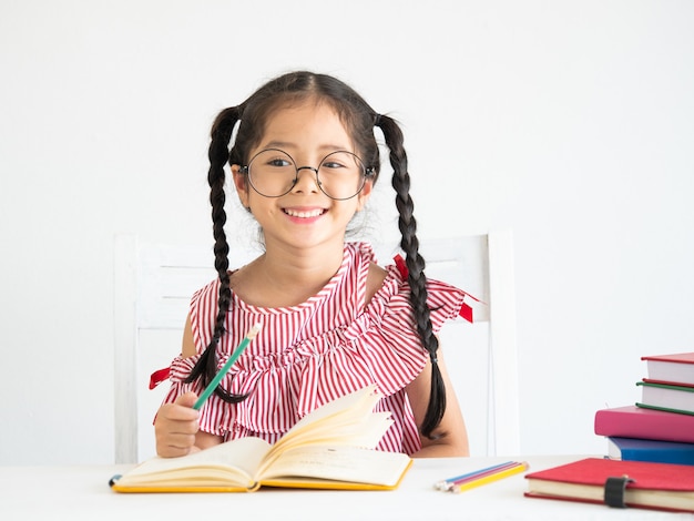 Asian cute girl with book on the desk 