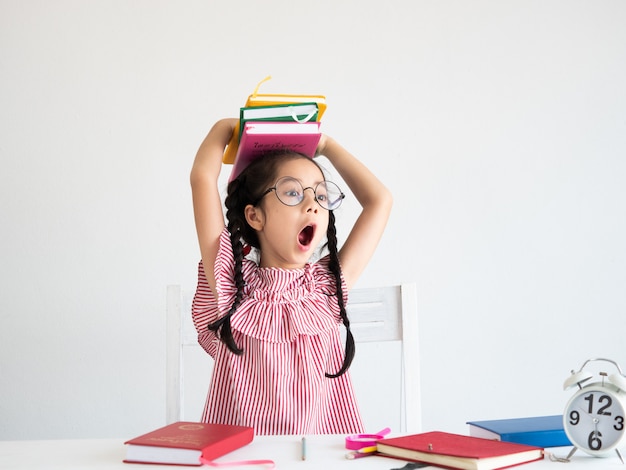 Asian cute girl with book on the desk 