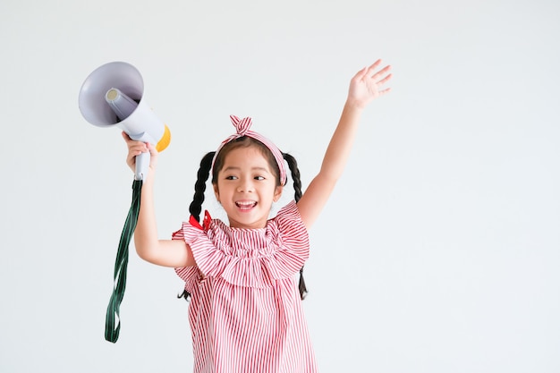 Asian cute girl with megaphone singing 