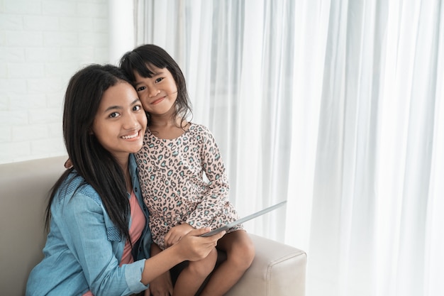 Asian cute happy sisters smiling