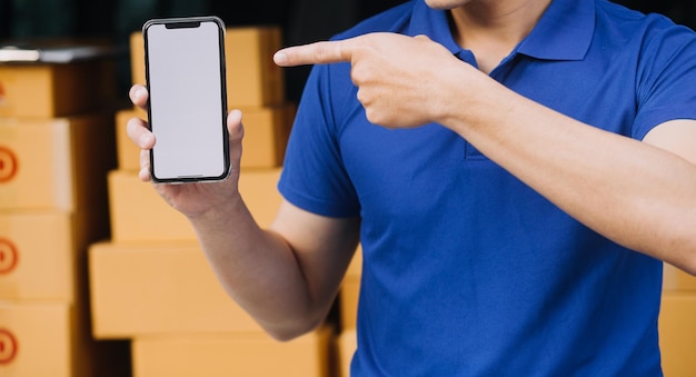 Asian delivery man in cargo van checking boxes