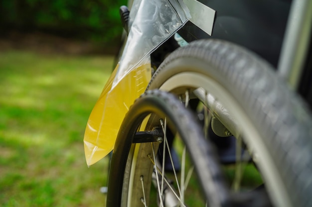 Asian disability woman with urine bag on wheelchair