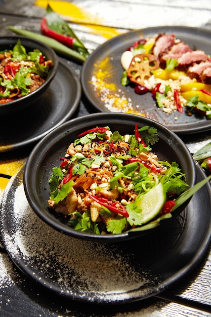 Asian dishes on a black wooden table