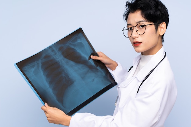 Asian doctor holding a bone scan