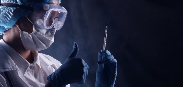 asian doctor lab woman in white uniform with stethoscope hygiene helmet, rubber gloves, syringe