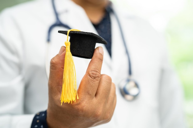 Asian doctor study learn with graduation gap hat in hospital ward clever bright genius