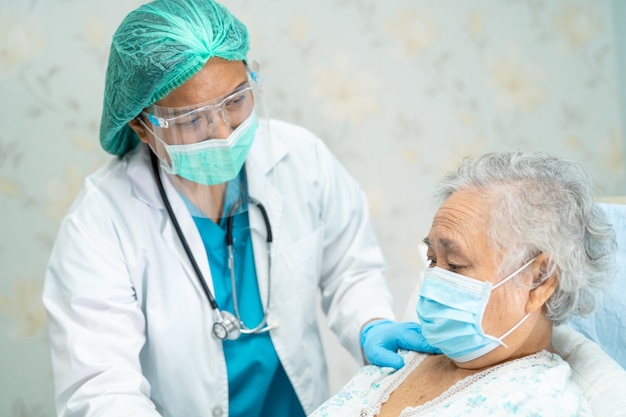 Asian doctor wearing face shield and PPE suit