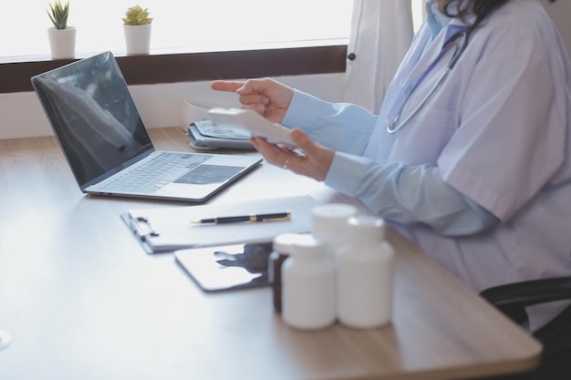 Asian doctor woman visited patient woman to diagnosis and check up health at home or private hospital Female patient explain health problem and symptoms to doctor Health care premium service at home