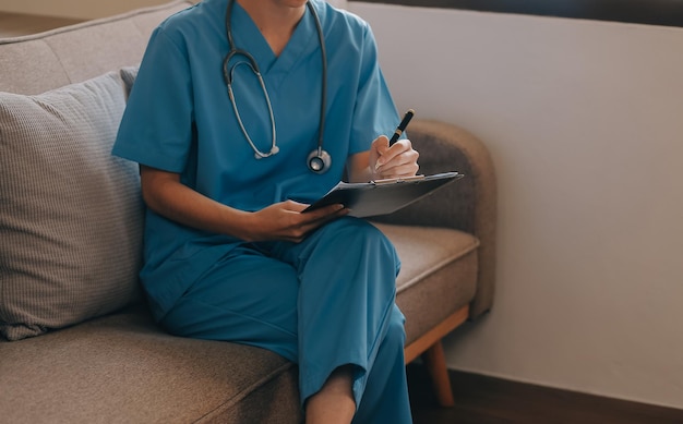 Asian doctor woman visited patient woman to diagnosis and check up health at home or private hospital Female patient explain health problem and symptoms to doctor Health care premium service at home