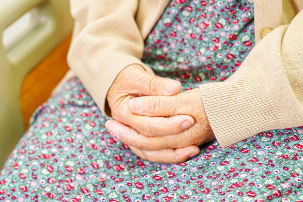 Asian elder senior woman patient put holding hands on herxAlap alone for waiting her family