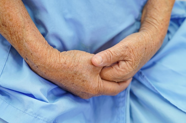 Asian elder senior woman patient put holding hands on herxAlap alone for waiting her family