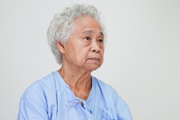 Asian elder senior woman patient sitting and smile face with\
happy on bed in hospital