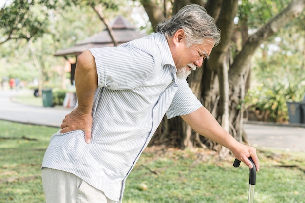 Asian elderly having pain on his back.