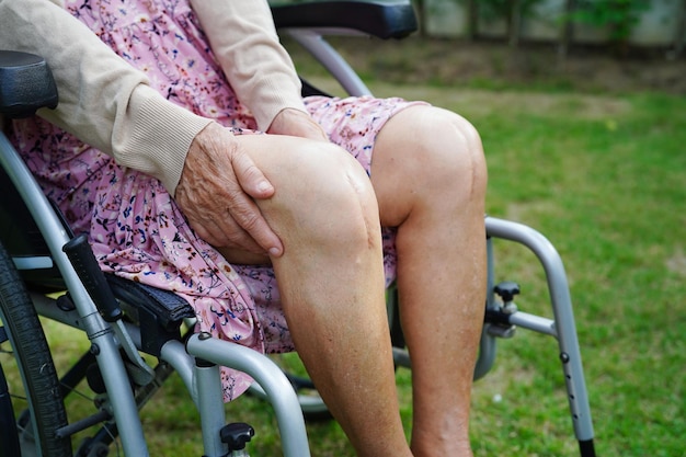 Asian elderly woman patient with scar knee replacement surgery\
in hospital