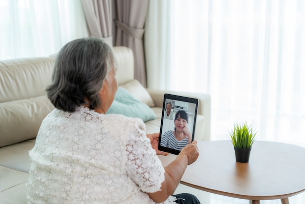 Asian elderly woman virtual happy hour meeting and talking online together with her daughter