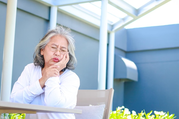 Asian elderly women have toothaches Dental diseases and oral diseases for the elderly concept of geriatric dentistry copy space