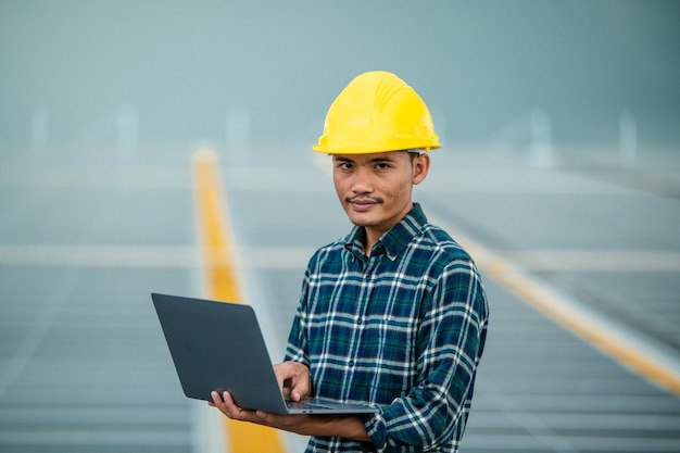 Asian engineer solar cell factory working with safety helmet outdoor