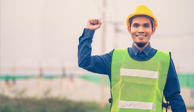 Asian engineer standing outdoor on site construction posting
confident engineer construction happy job success with in target
planning