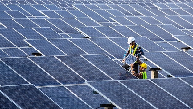 Asian engineer working on checking equipment in solar power plant, Pure energy, Renewable energy