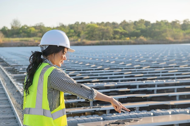 Asian engineer working at Floating solar farmRenewable energyTechnician and investor solar panels checking the panels at solar energy installation