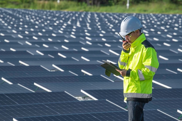 Asian engineer working at Floating solar power plantRenewable energyTechnician and investor solar panels checking the panels at solar energy installation