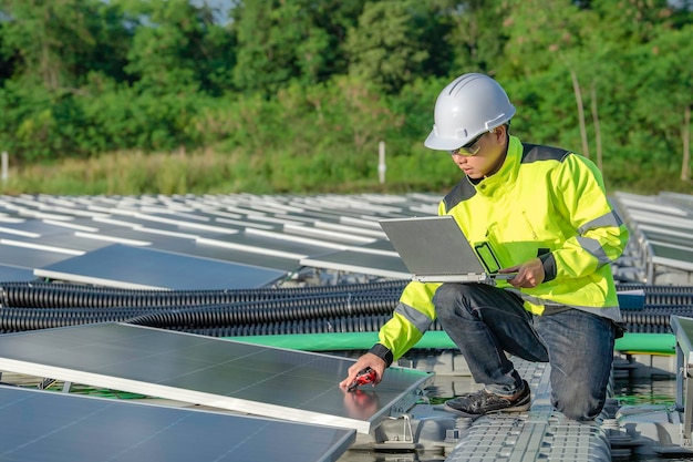 Asian engineer working at Floating solar power plantRenewable energyTechnician and investor solar panels checking the panels at solar energy installation