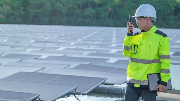 Asian engineer working at Floating solar power plantRenewable energyTechnician and investor solar panels checking the panels at solar energy installation