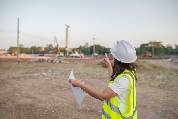 Asian engineer working at site of a large building projectThailand peopleWork overtime at construction site