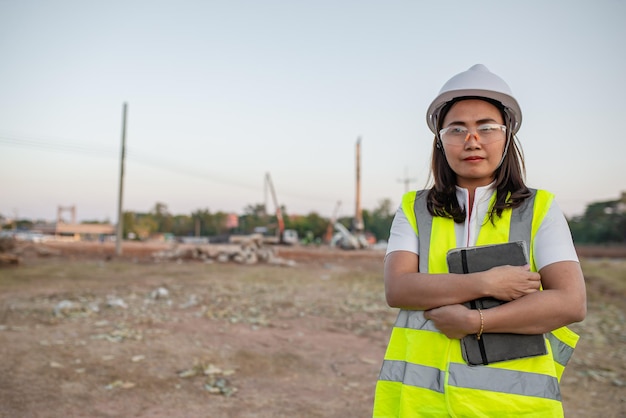 Asian engineer working at site of a large building\
projectthailand peoplework overtime at construction site