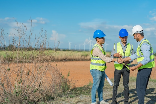 Asian engineers working in fieldwork outdoor. Workers walking and inspect construction and machine.