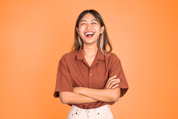 Asian ethnicity female looking at camera smiling with crossed arm