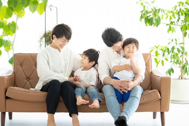 Asian family frolicking on the couch