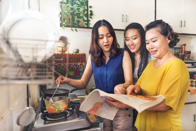 Asian family is cooking in the kitchen together