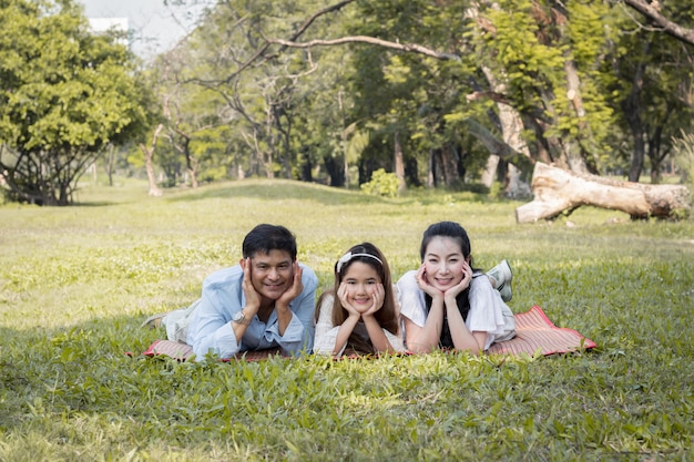 Asian family lying on the mat.